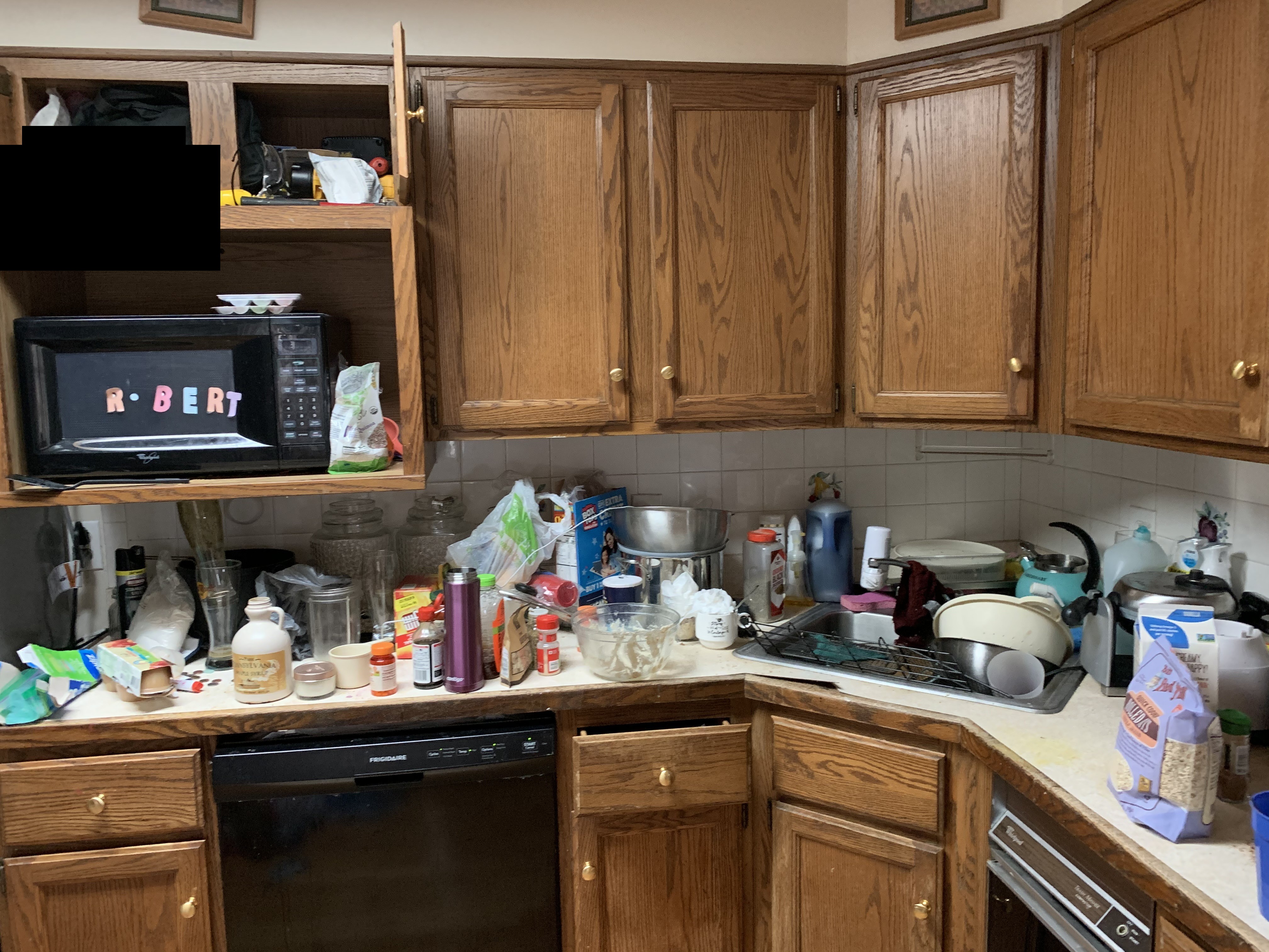 Kitchen before cleaning - cluttered countertops